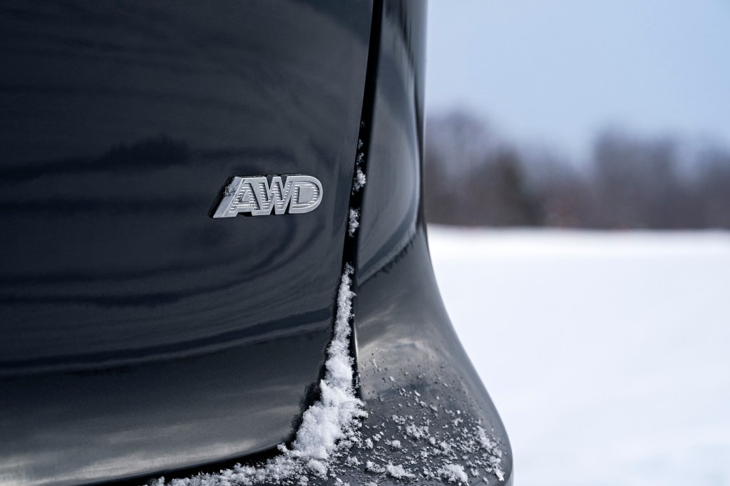 the AWD insignia on the back of a black Pacifica minivan