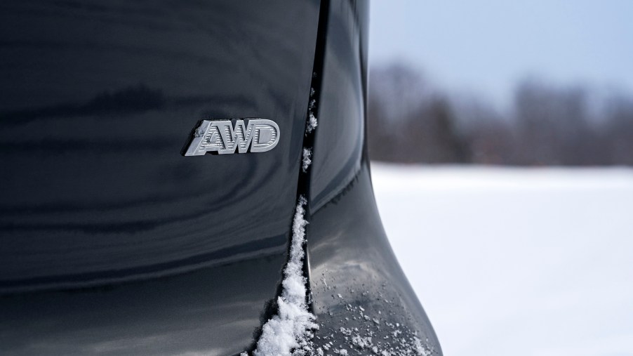 the AWD insignia on the back of a black Pacifica minivan
