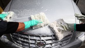 Workers detail a car