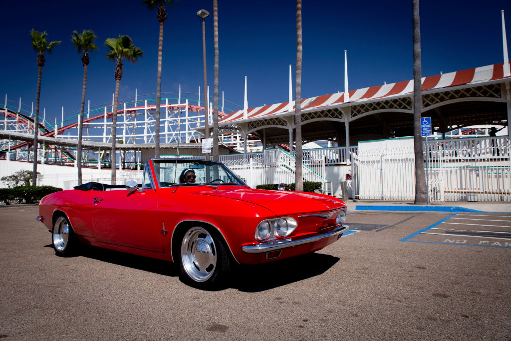a red convertible Chevrolet Corvair 