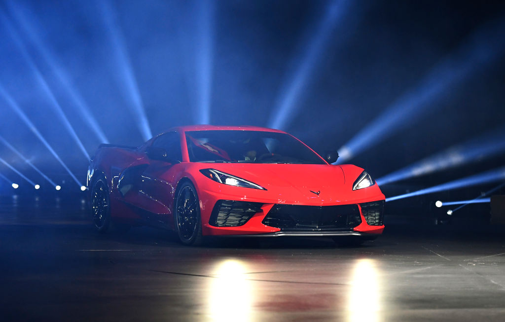 Red C8 Corvette on stage with rays of light