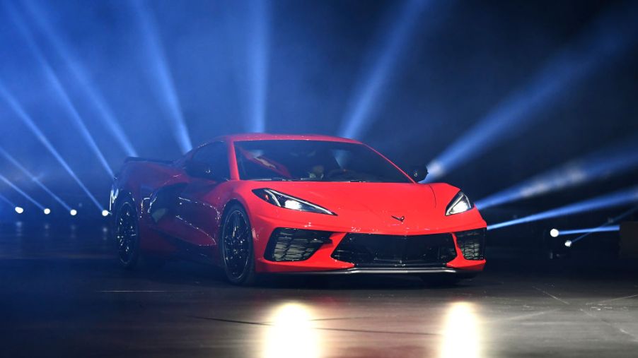 Red C8 Corvette on stage with rays of light