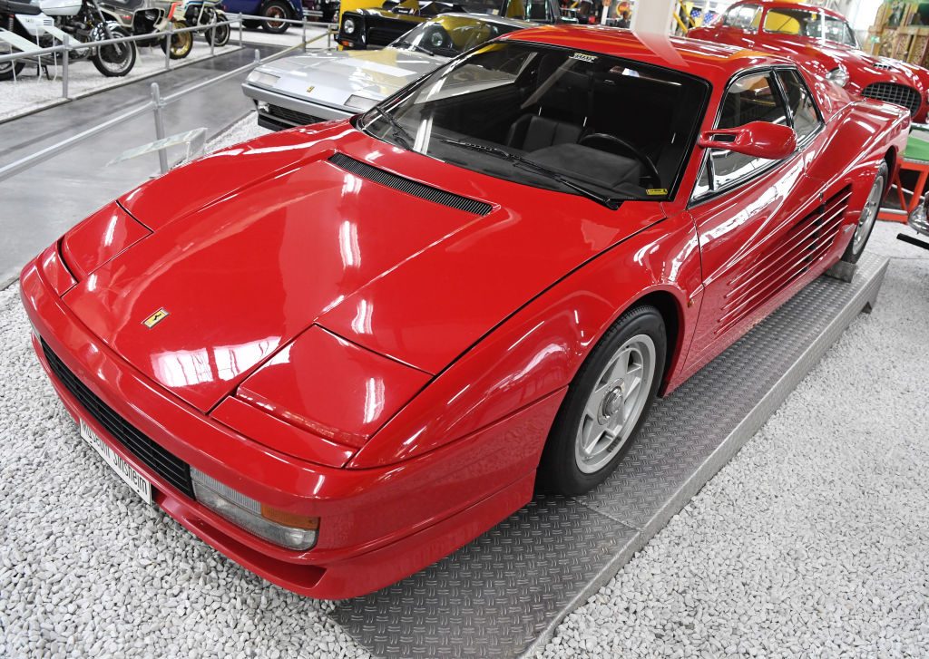 A red Ferrari Testarossa sits in an indoor display.