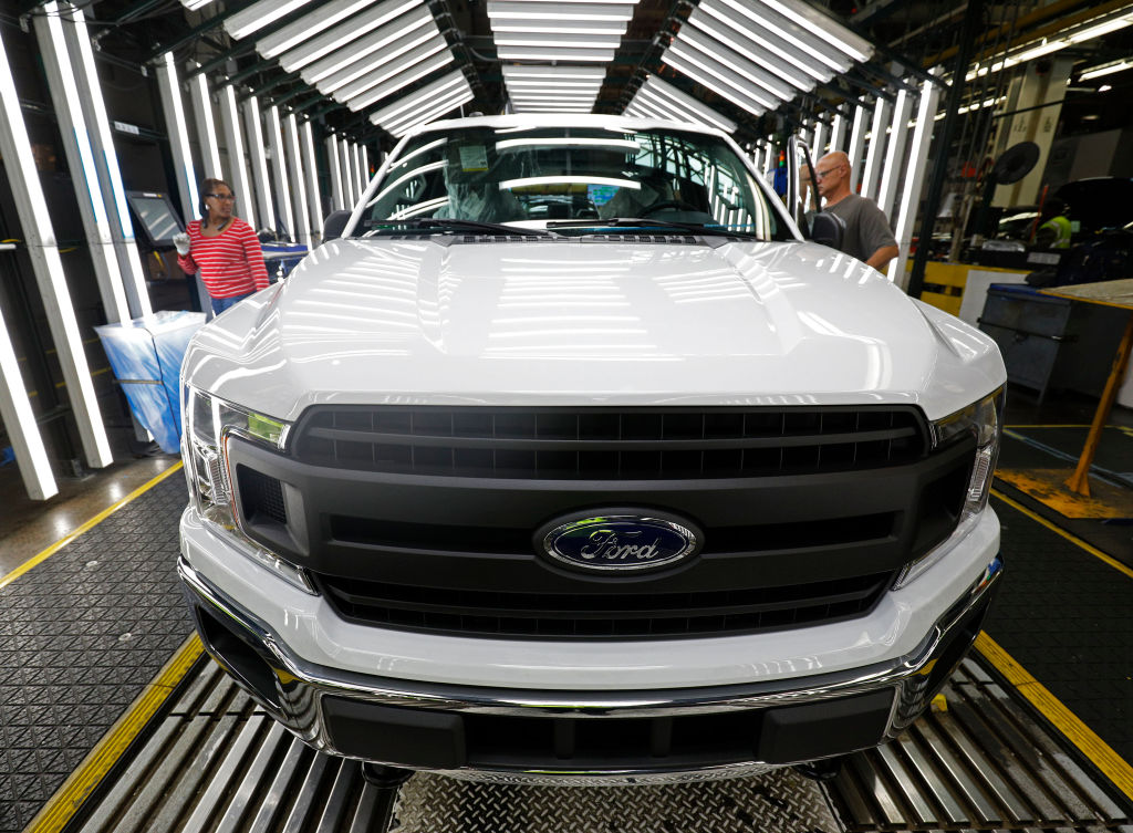 Ford F-150 trucks go through the customer acceptance line at the Ford Dearborn Truck Plant on September 27, 2018
