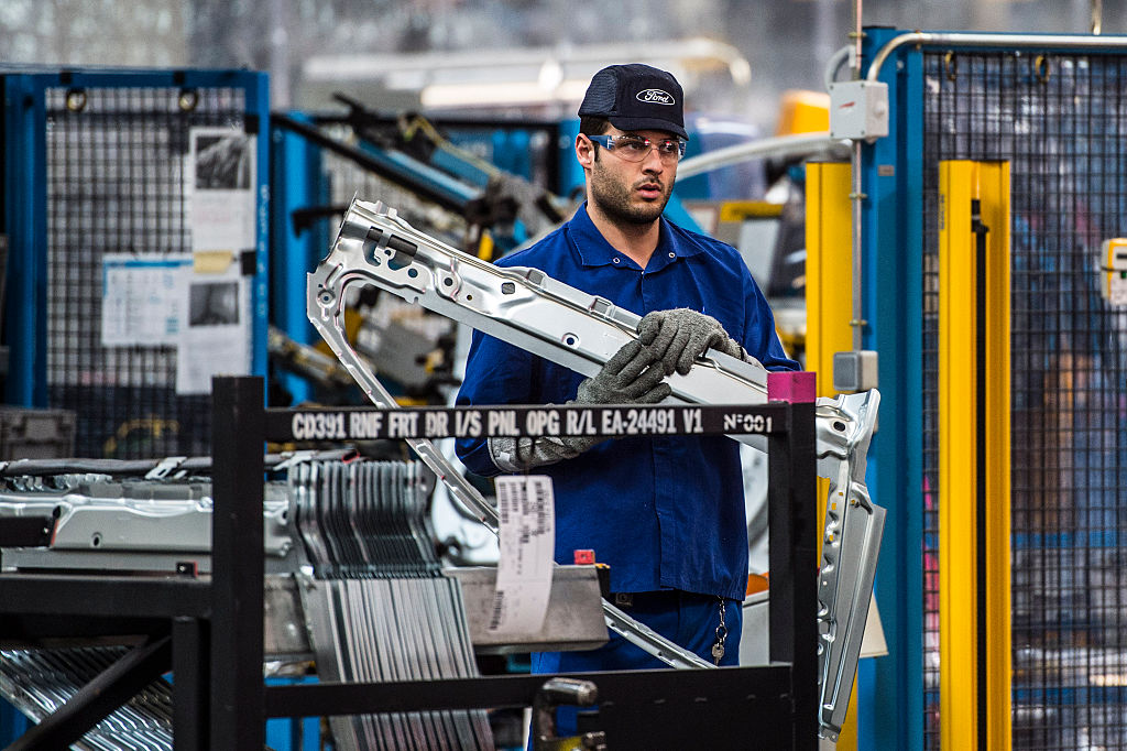 An employee works on Ford Mondeo vehicles on the production line during assembly at Ford plant in Almussafes