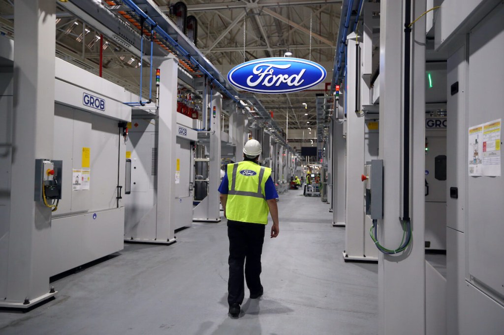 A Ford worker walks through the plant