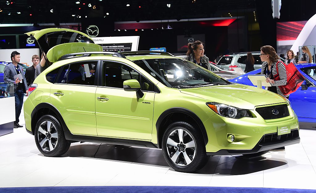 A green Subaru Crosstrek on display at an auto show