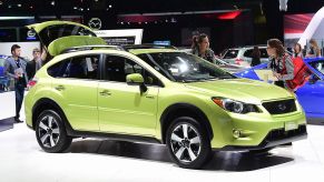 A green Subaru Crosstrek on display at an auto show
