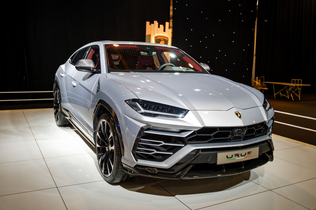 A new Lamborghini Urus on display at an auto show