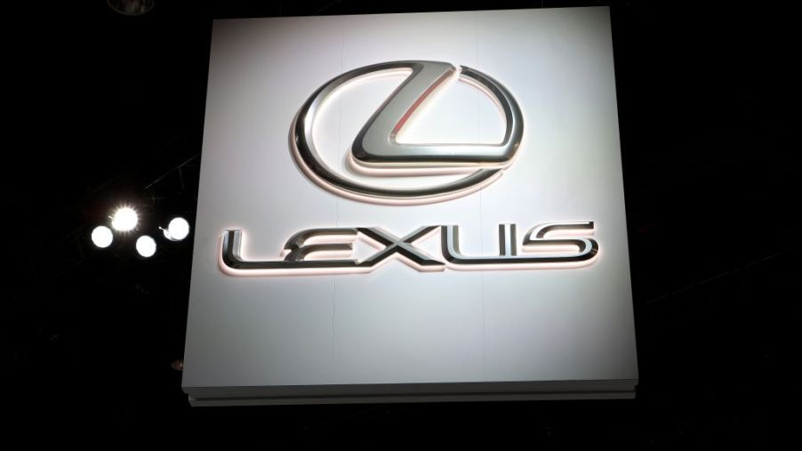 An illuminated Lexus sign at an auto show
