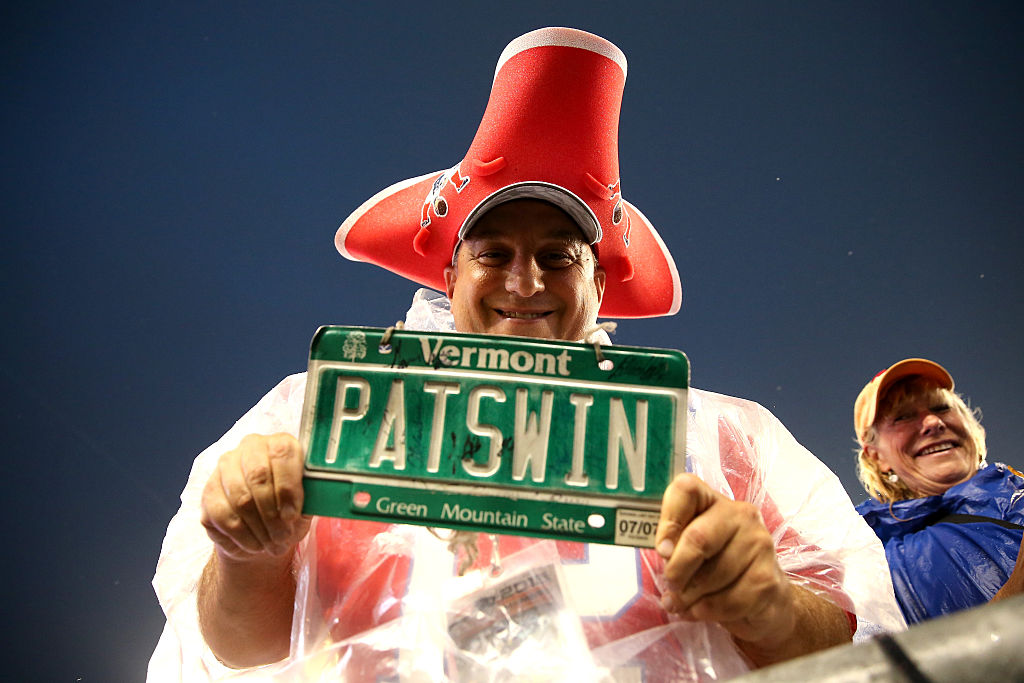 A New England Patriots fan holds a Vermont "Pats Win" license plate before the game against the Pittsburgh Steelers at Gillette Stadium on September 10, 2015