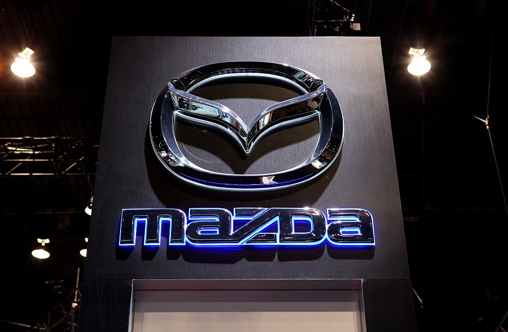 A Mazda logo glowing on a sign