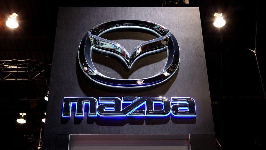 A Mazda logo glowing on a sign
