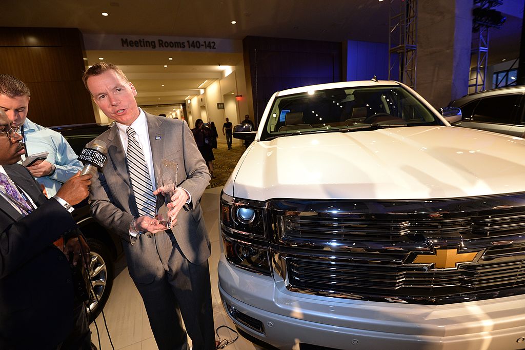 Chief Engineer of GM's full and mid-size trucks, Jeff Luke(C) accepts the North American Car and Truck of the year award for the Silverado truck, January 13, 2014 at the 2014 Detroit Auto Show