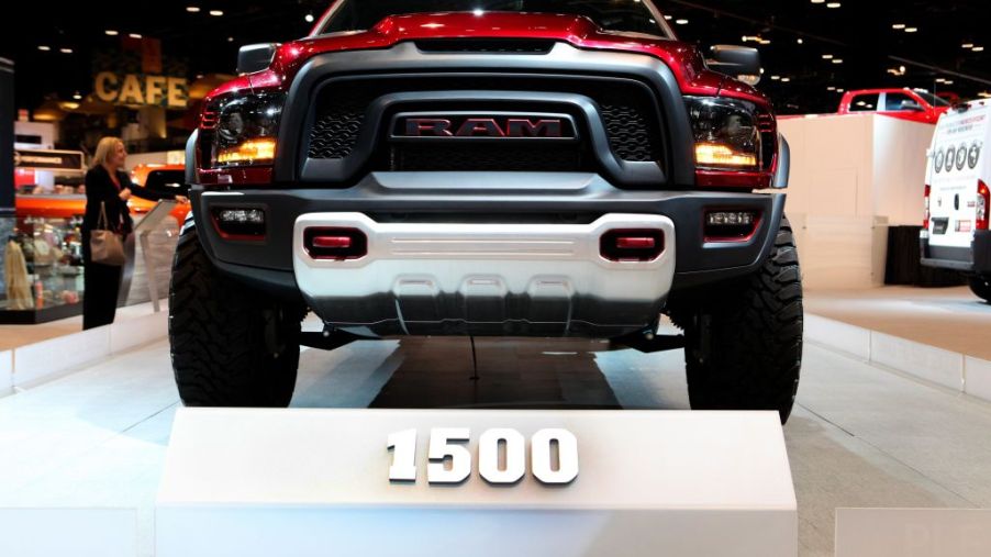 A red Ram 1500 truck on display at an auto show