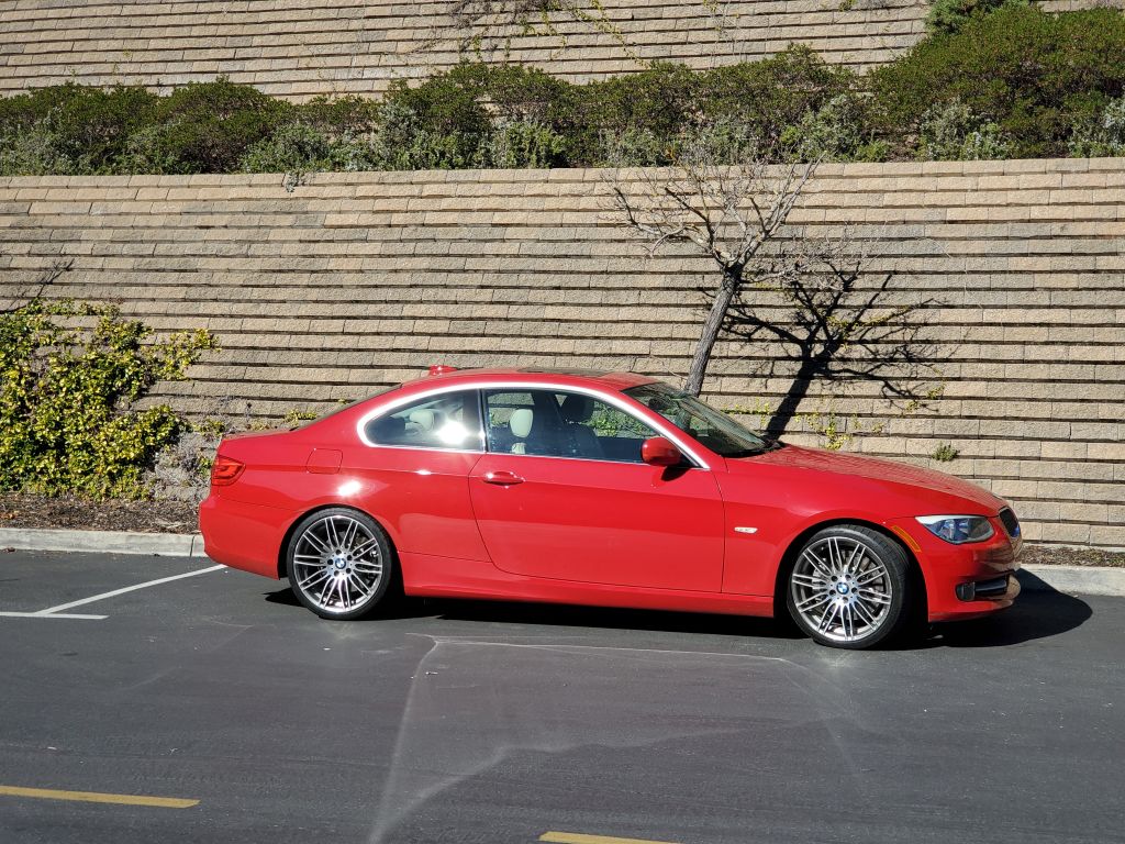 Red BMW automobile parked below a retaining wall in Lafayette, California, February 5, 2020