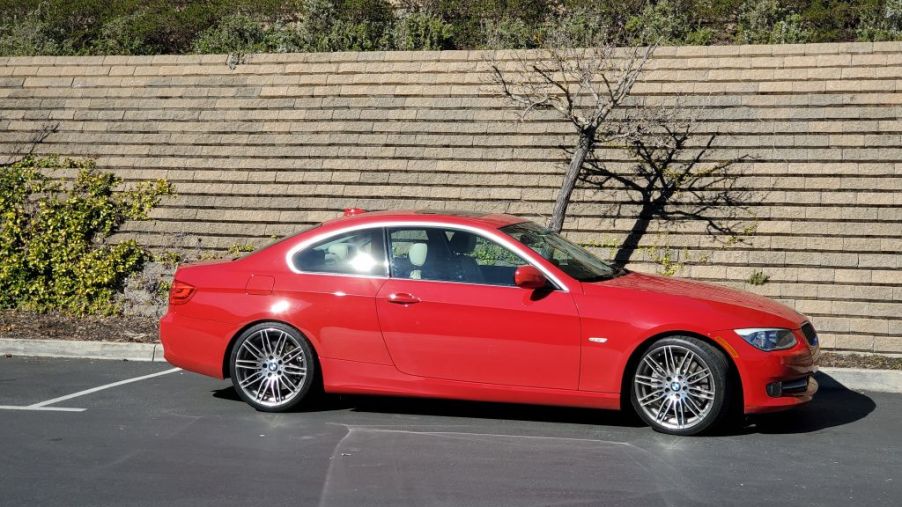 Red BMW automobile parked below a retaining wall in Lafayette, California, February 5, 2020