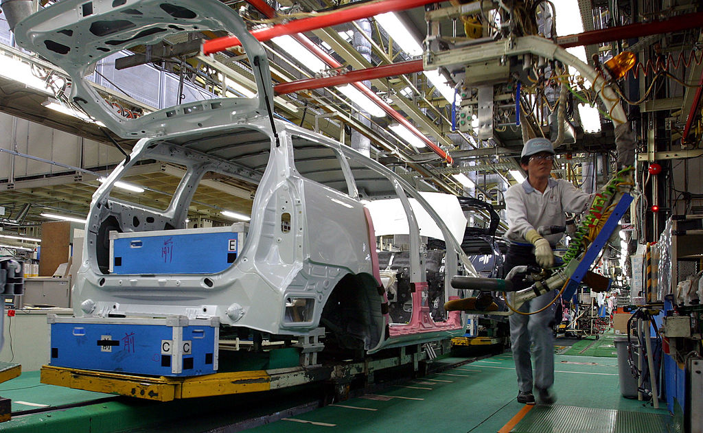 Toyota Motor Corporation employees assemble a car at the Tsutsumi Plant February 20, 2003 in Tokyo