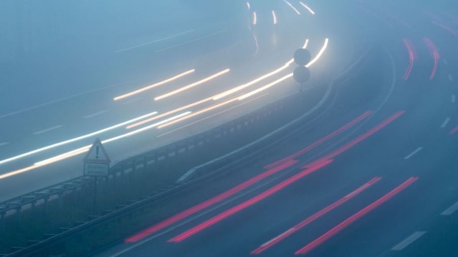 Vehicles are driving in the morning in fog