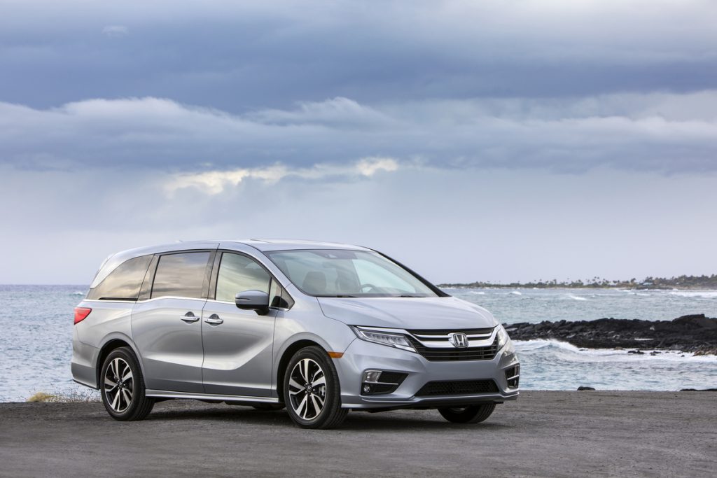 a silver Honda Odyssey parked on a picturesque seashore
