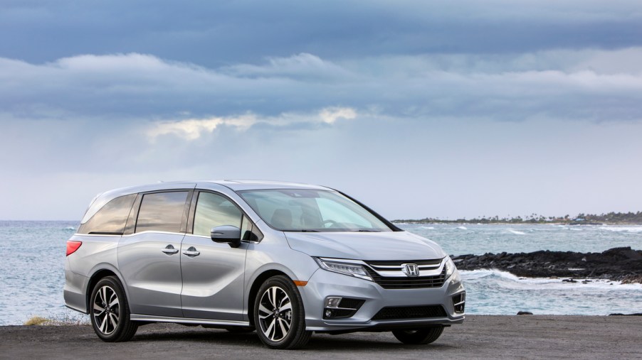 a silver Honda Odyssey parked on a picturesque seashore