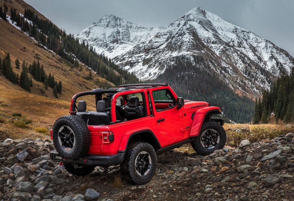 The 2023 Jeep Wrangler off-roading over rocky terrain