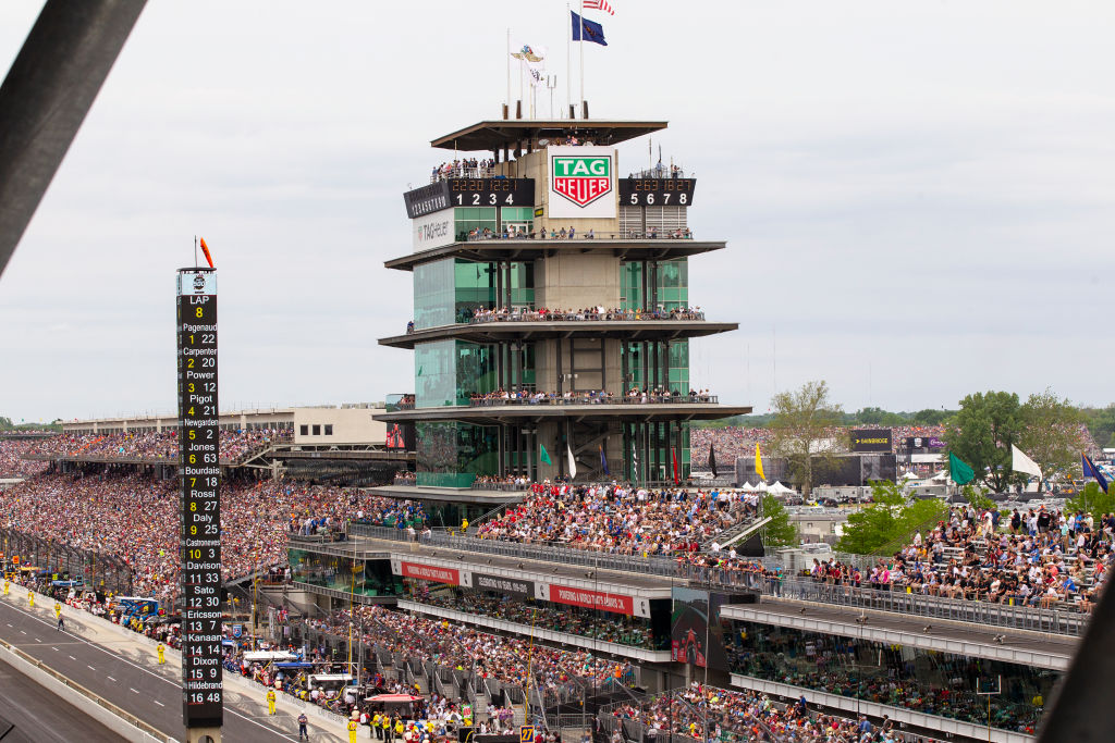 A crowd of fans attending the 2019 Indianapolis 500, filling the stands. 