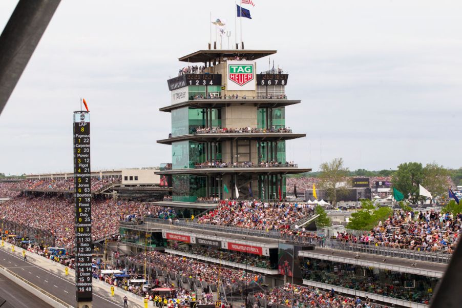 A crowd of fans attending the 2019 Indianapolis 500, filling the stands.