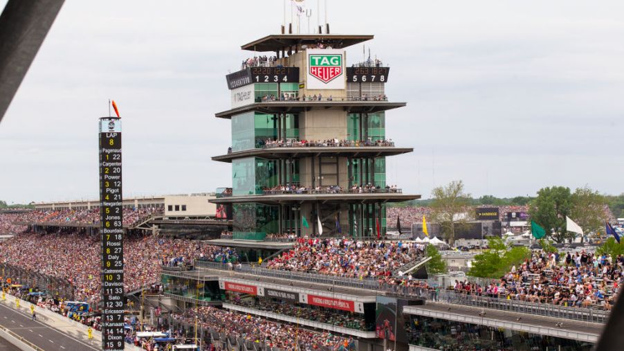 A crowd of fans attending the 2019 Indianapolis 500, filling the stands.