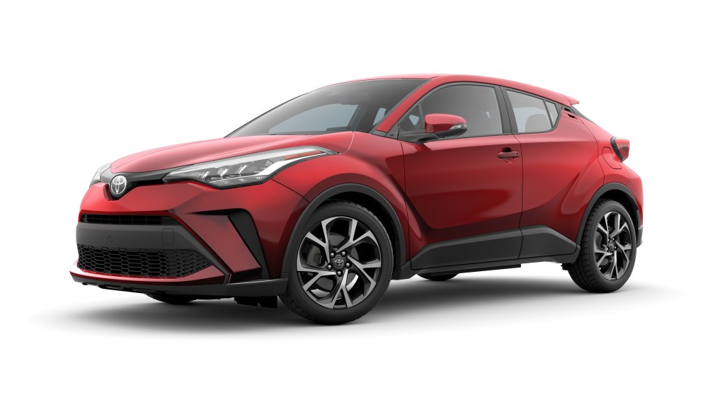 A red 2020 Toyota C-HR parked in front of a white background. 