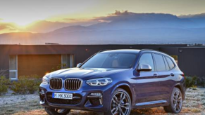A blue 2021 BMW X3 at sunset.