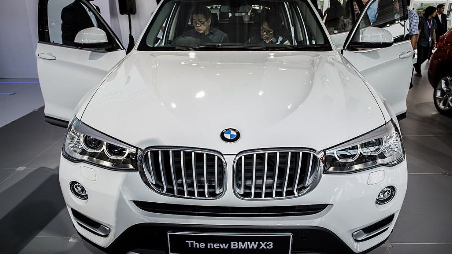 Visitors look inside the new BMW x3 at The 22st Indonesia International Motor Show