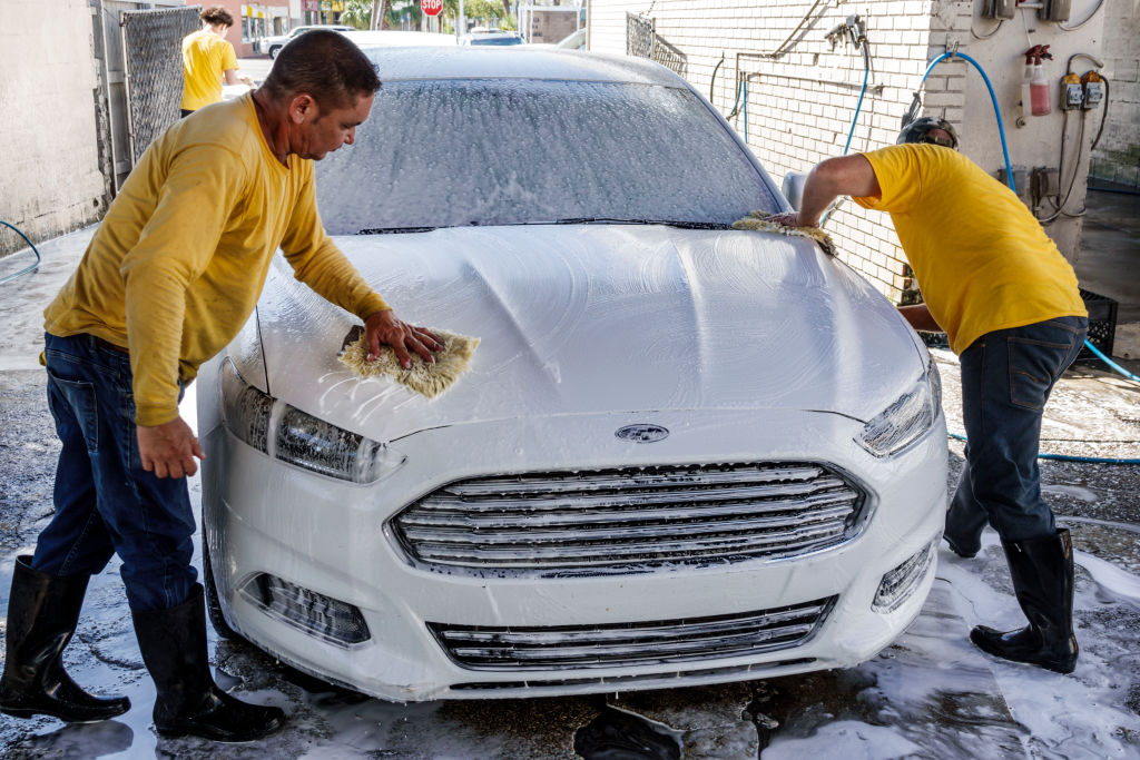 Miami, Little Havana, men working at car wash. 