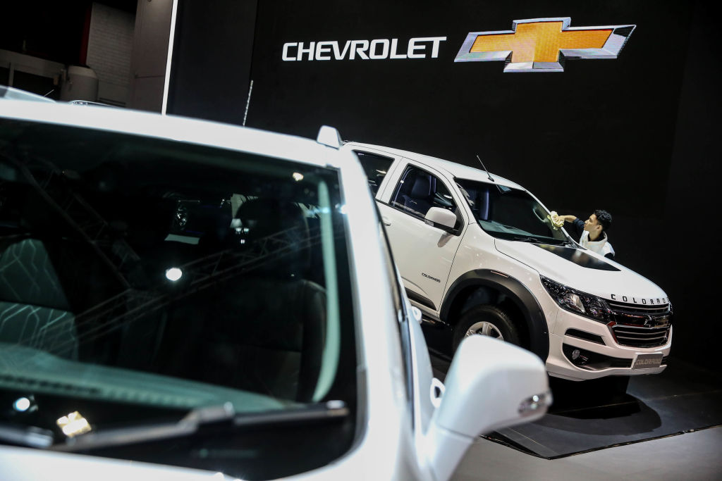 A worker cleans a Chevrolet Colorado displayed at the Indonesian International Motor Show