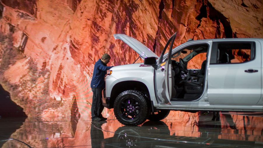 A man looks at a Chevrolet Silverado truck at the auto trade show, AutoMobility LA, at the Los Angeles Convention Center