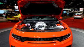 A 2020 Dodge Charger on display with its engine showing
