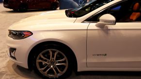 A white Ford Fusion on display at an auto show