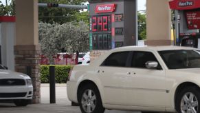 A sign indicates that the price per gallon of regular gas is $2.42 at a gas station on June 13, 2019 in Miami, Florida