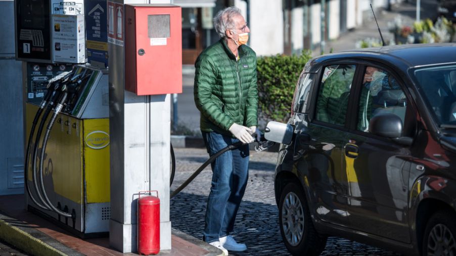 A man with mask makes gasoline from a gas station in Turin during on the Italy Extends Coronavirus Lockdown