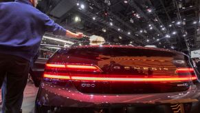 A man dusts the new-unveiled Genesis G90 at AutoMobility LA