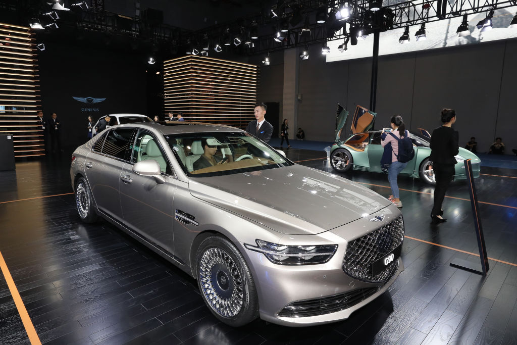 People look at a Hyundai Genesis G90 car during the 2nd China International Import Expo (CIIE) at the National Exhibition and Convention Center