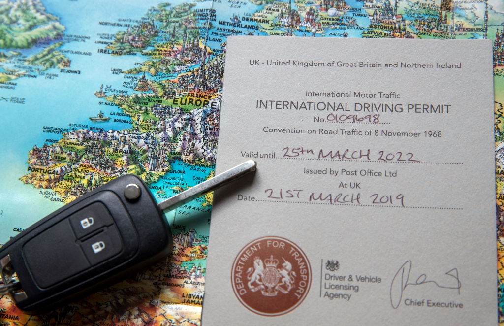 A UK International Driving Permit (IDP) placed on a map of Europe.