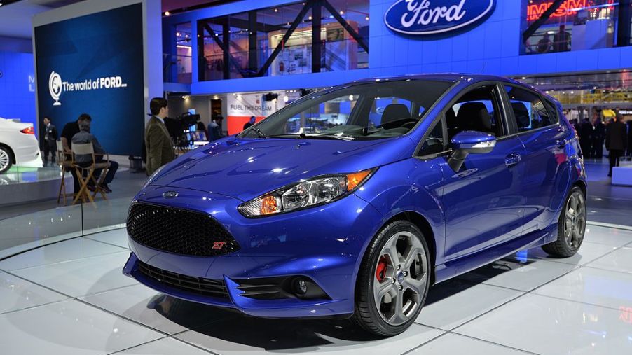 A blue first-generation Ford Fiesta ST displayed at an autoshow.