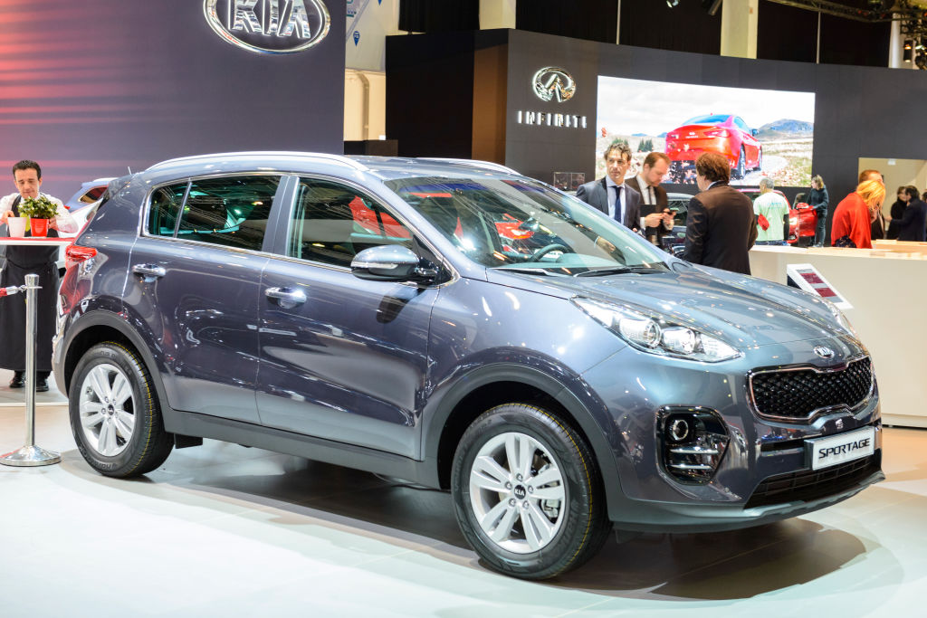 A new Kia Sportage on display at an auto show demonstrates a consumer reports recommendation for a compact crossover SUV