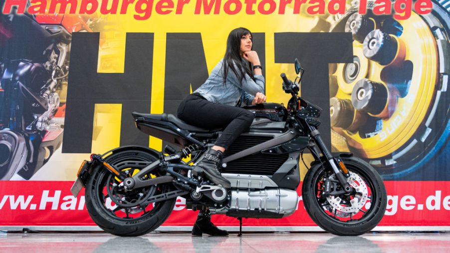 A model poses on a Harley-Davidson electric motorcycle during a press conference for the Hamburg Motorcycle Days