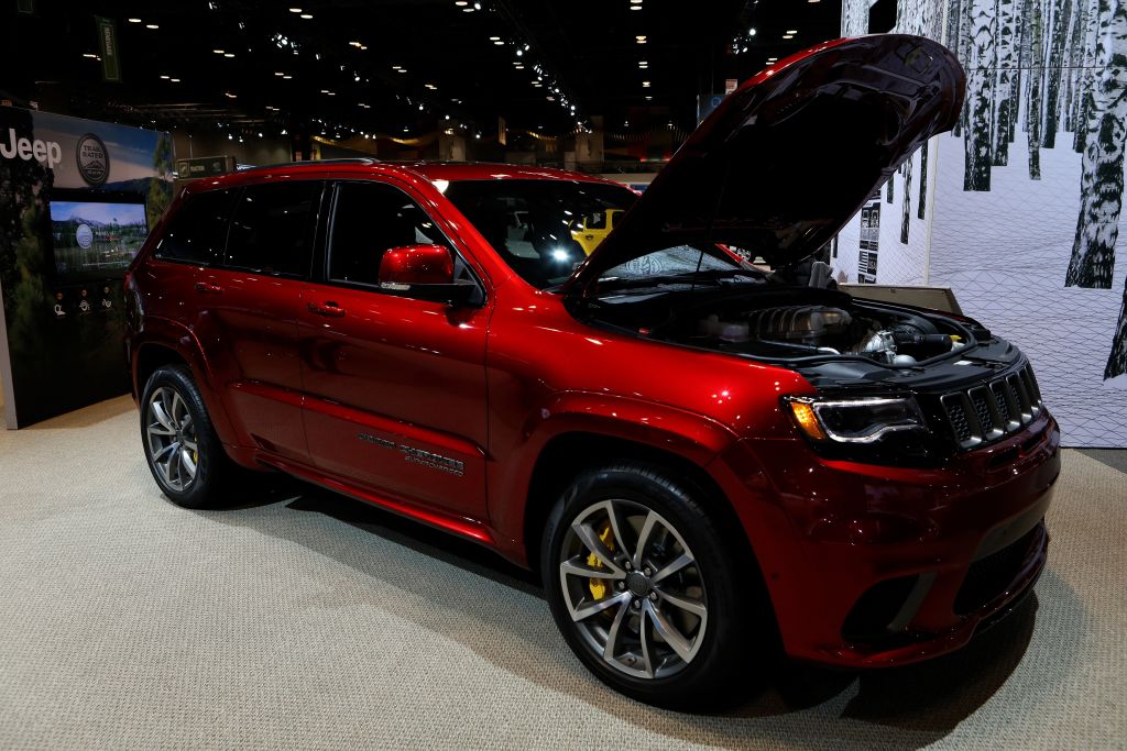 The Jeep Grand Cherokee Trackhawk SUV on display at an auto show