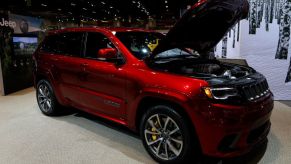 The Jeep Grand Cherokee Trackhawk SUV on display at an auto show
