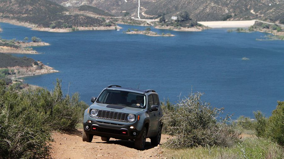 Jeep Renegade driving up dirt road near beach