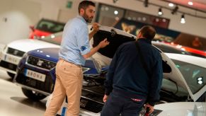 A car salesman showing a customer around