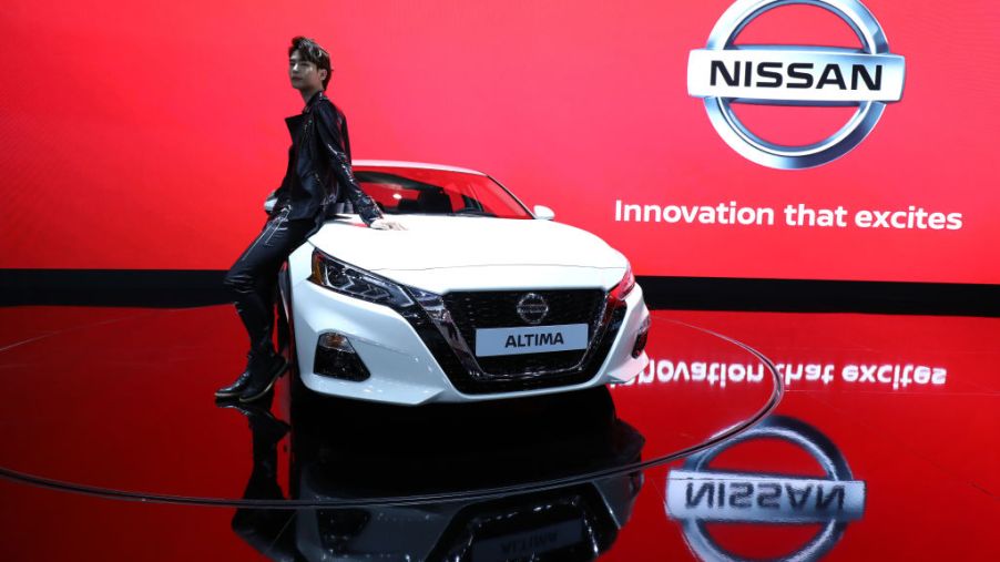 A model poses next to a NISSAN Altima at the Seoul Motor Show 2019